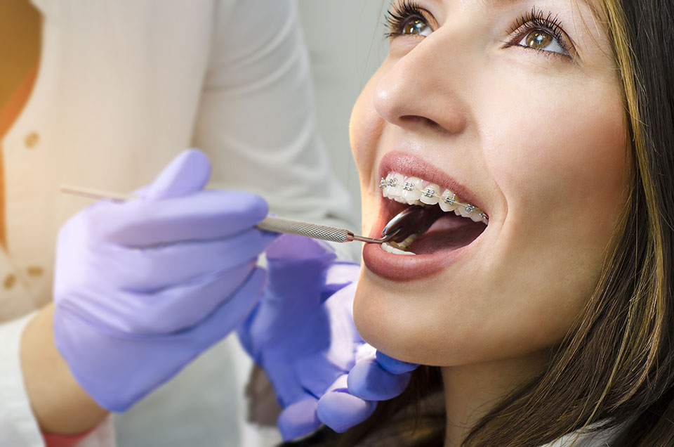 girl with braces getting a dental checkup