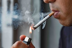 man lighting a cigarette